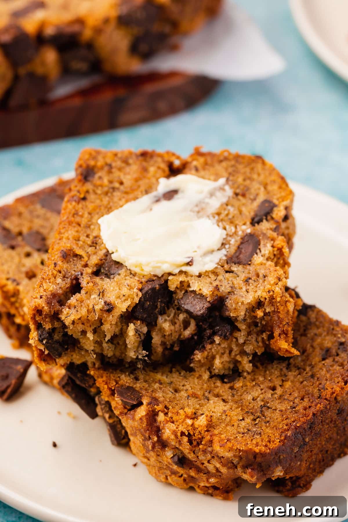 Two slices of gluten-free banana bread slathered with vegan butter.