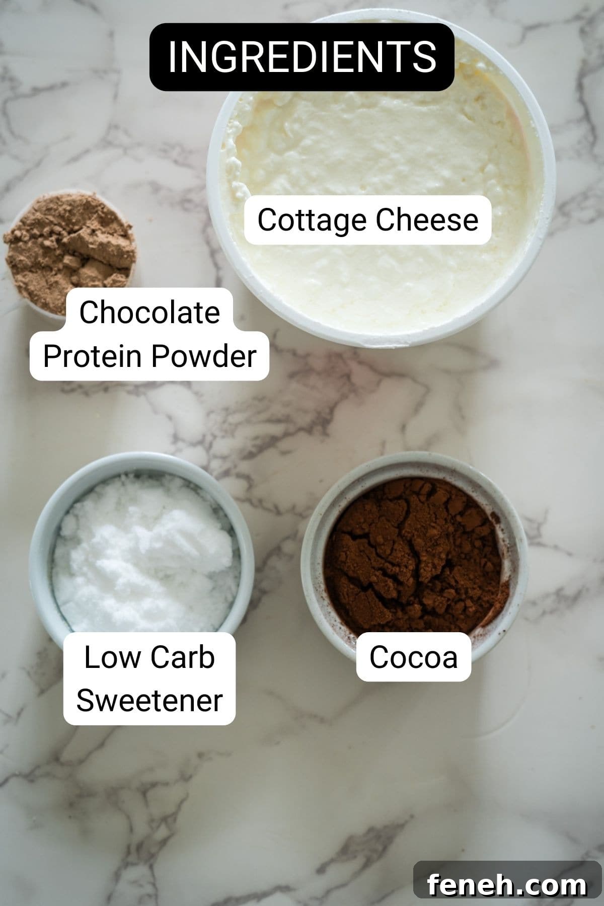Labeled ingredients on a marble surface: cottage cheese, chocolate protein powder, low carb sweetener, and cocoa.