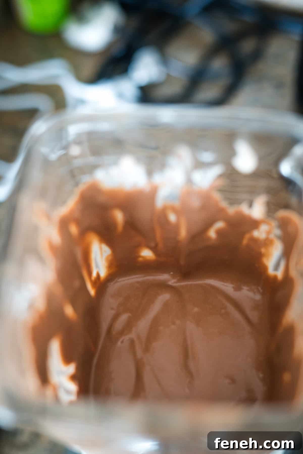 Close-up of a bowl containing partially melted chocolate, with some chocolate smeared along the sides.