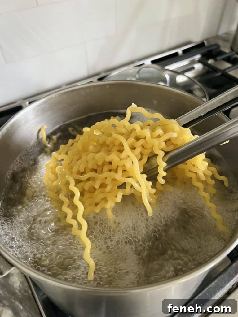 Fusilli being cooked in boiling water.