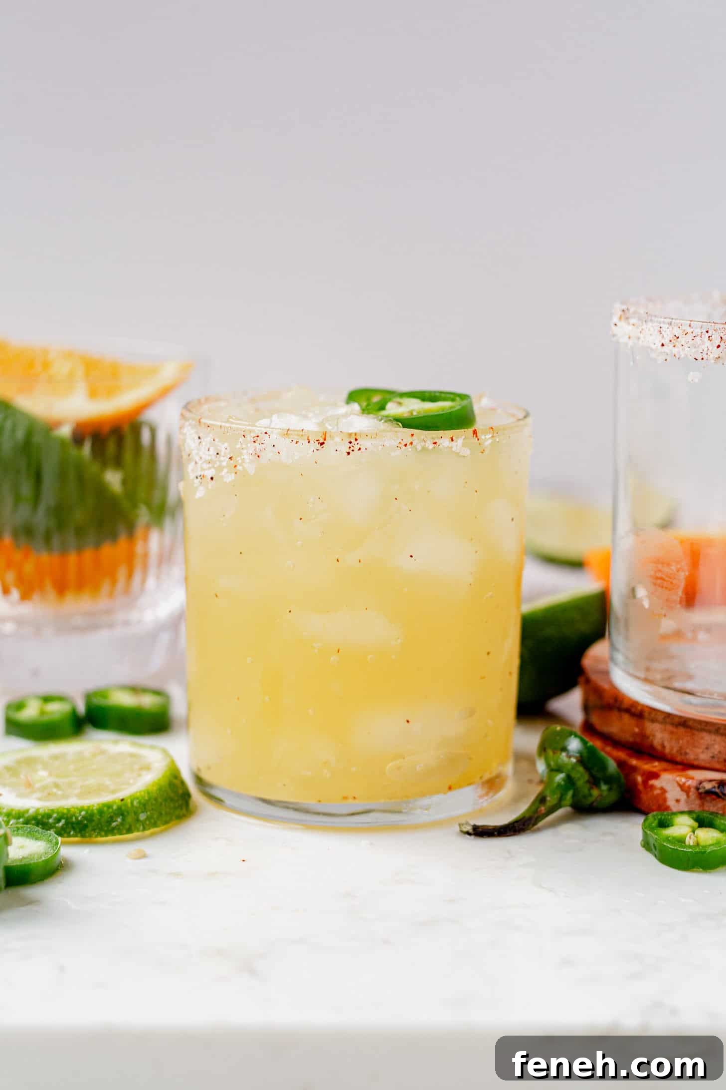 skinny spicy margarita with jalapeno on a marble serving tray