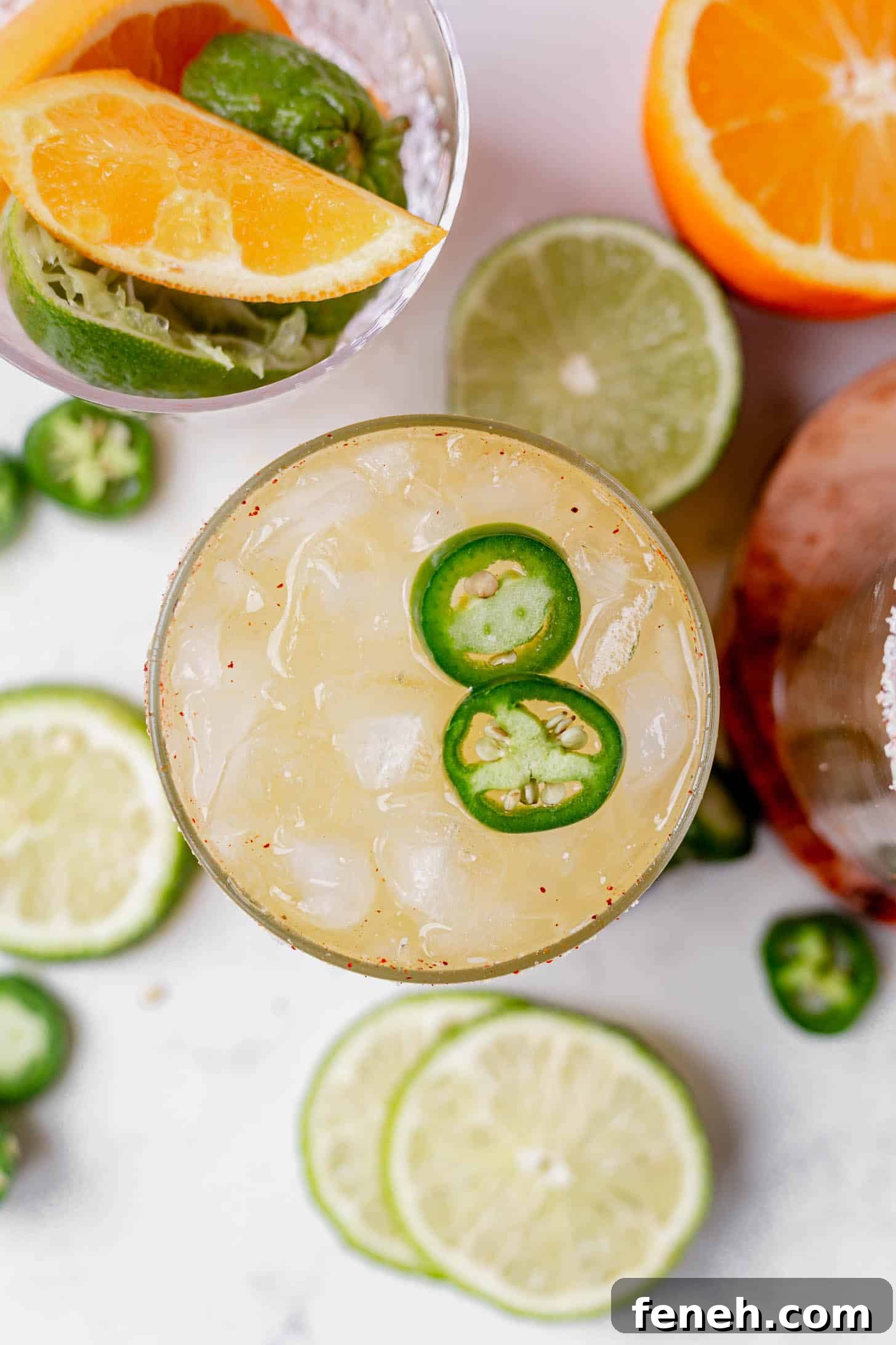 two jalapeno slices on top of a skiny spicy margarita