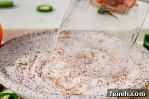 dipping a margarita glass in salt and Tajin