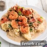Shrimp and grits with some delicious bacon and green onions sprinkled on top.