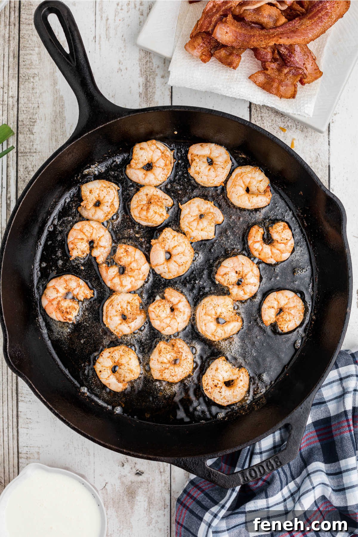 Shrimp being cooked in a cast iron pan.