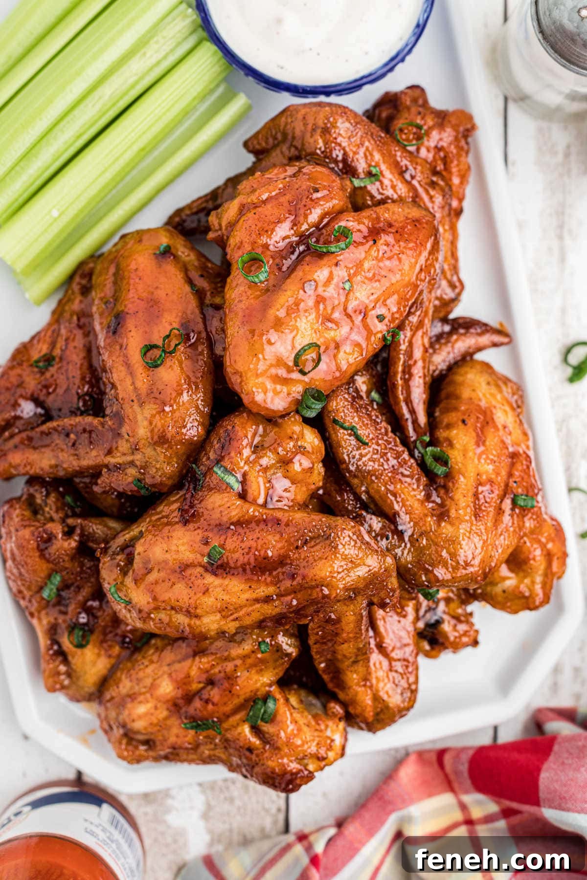Closeup of finished chicken wings in a spicy bbq sauce.