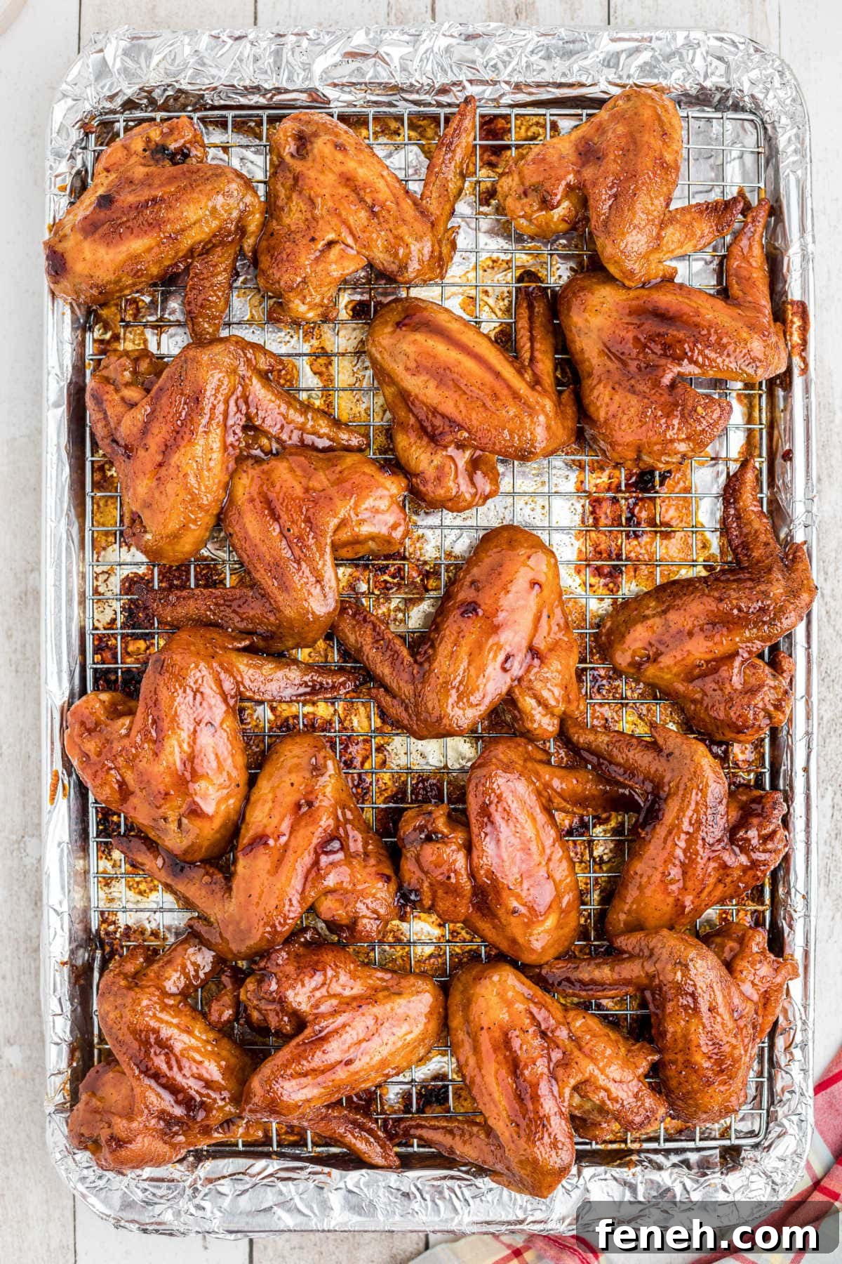 Overhead view of baked wings that have been dipped in glaze.