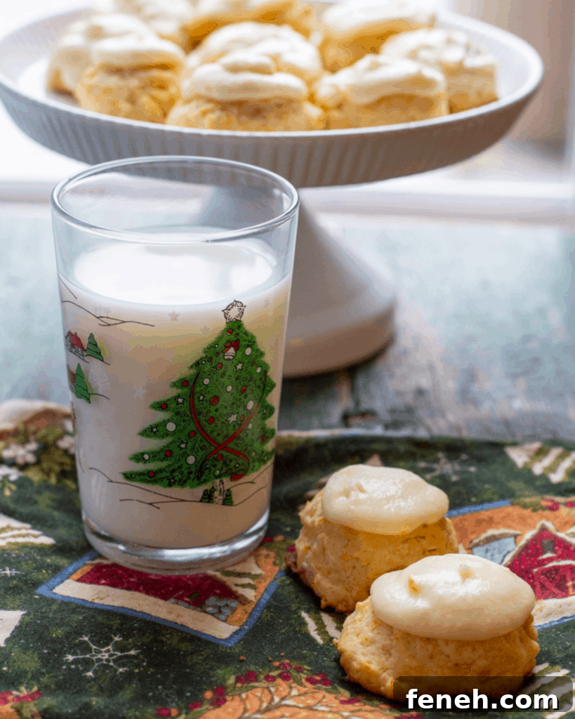 A plate full of Carrot Cookies with Orange Icing
