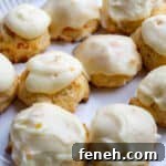 A plate of carrot cookies with orange icing, close up