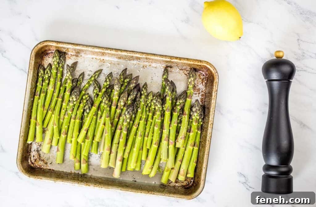 Asparagus on a sheet pan ready for roasting.