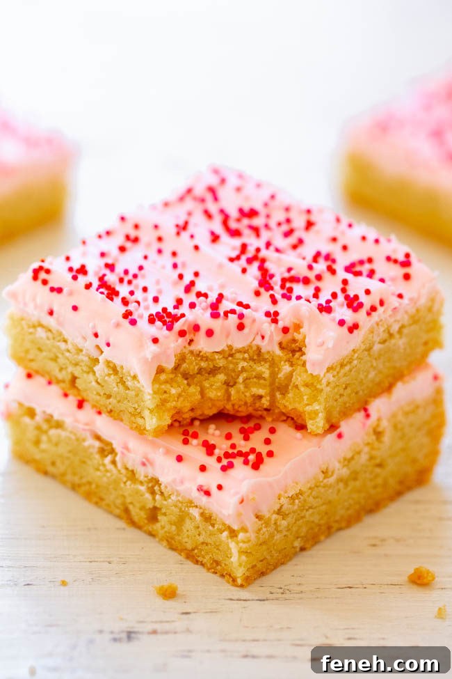 Red Velvet Cupcakes with Silky Vanilla Cream Cheese Frosting 14 Two stacked Valentine’s Frosted Sugar Cookie Bars with the top bar missing a bite.