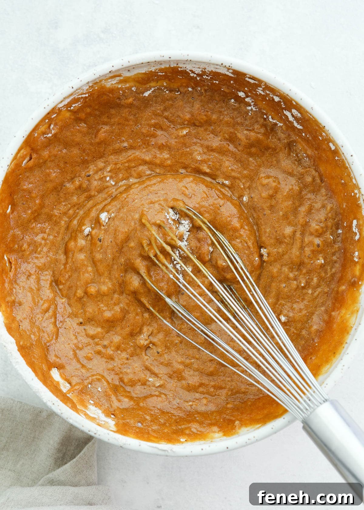 mixing pumpkin roll cake batter in bowl