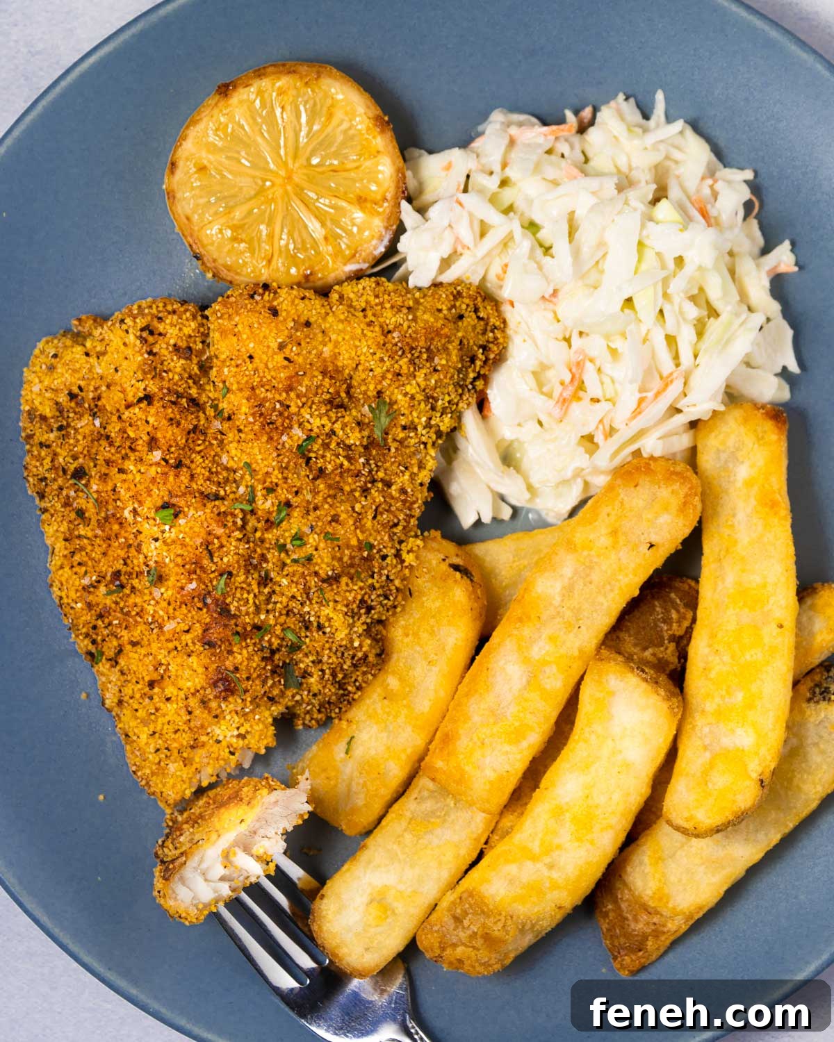 plate of air fryer catfish with a bite on the fork.