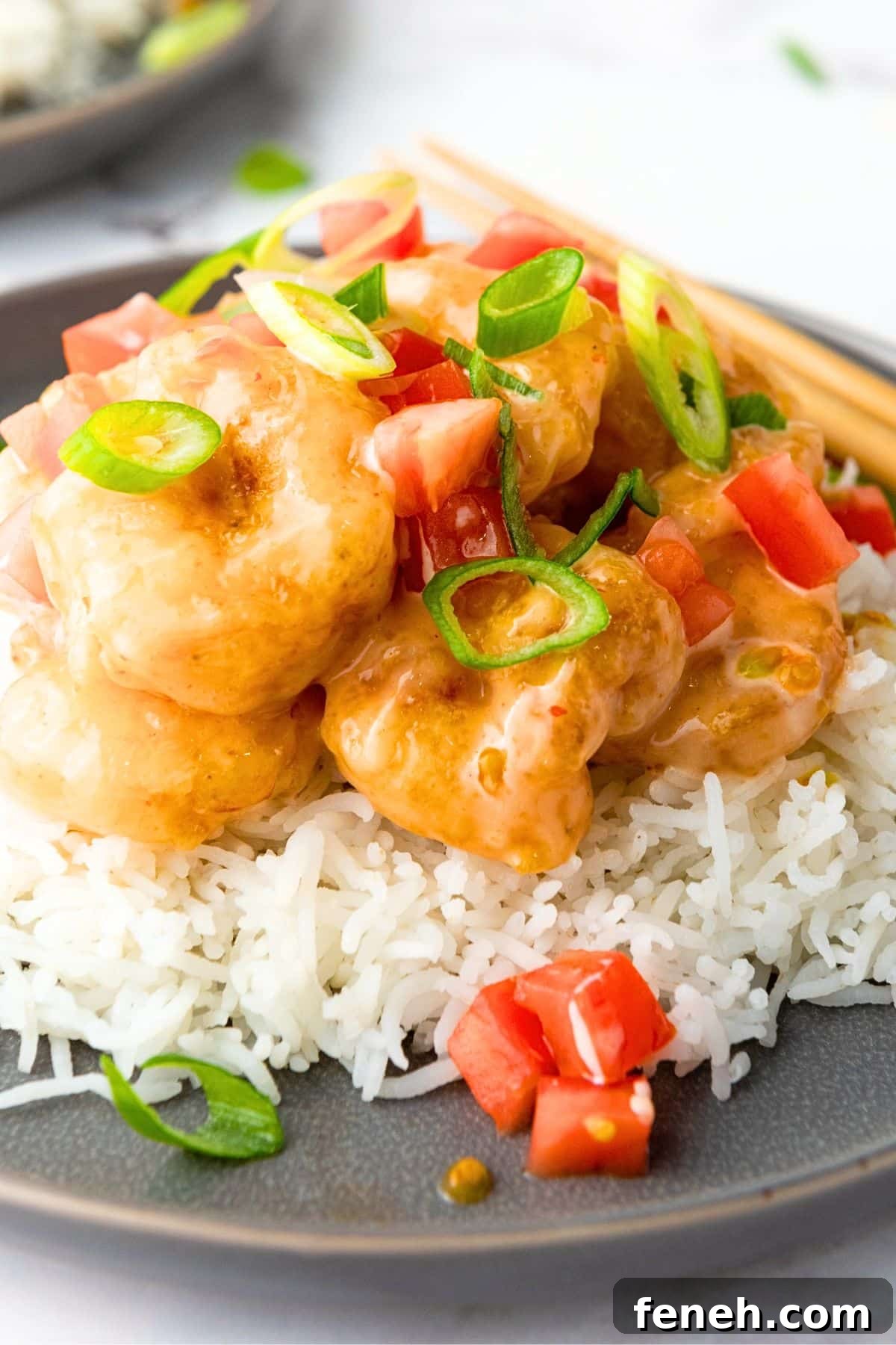 Up close shot of gluten-free bang bang shrimp over rice.