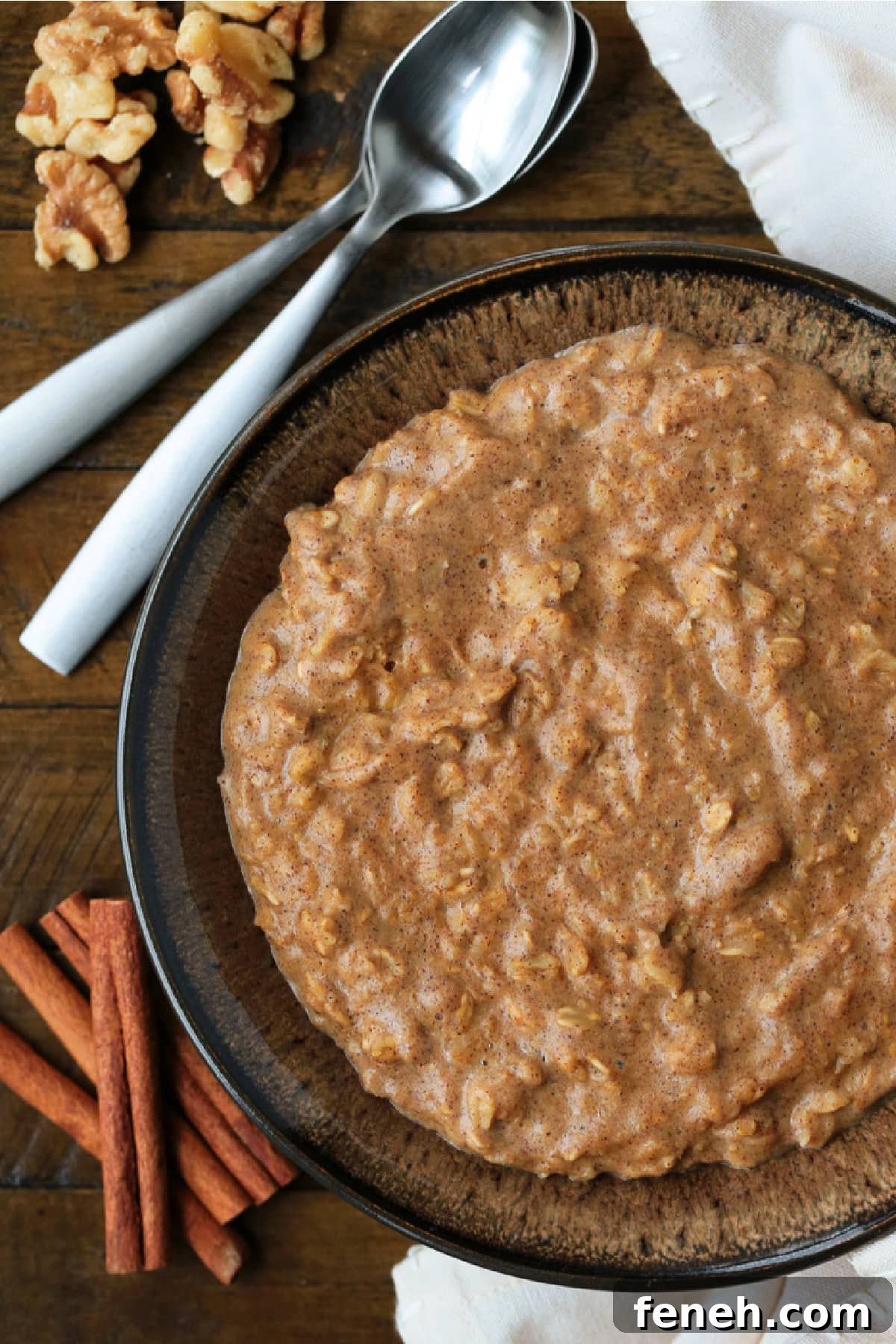 pumpkin oatmeal in a brown bowl with spoons