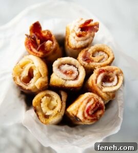 close up over shot of sandwich roll ups in small tin with white parchment paper