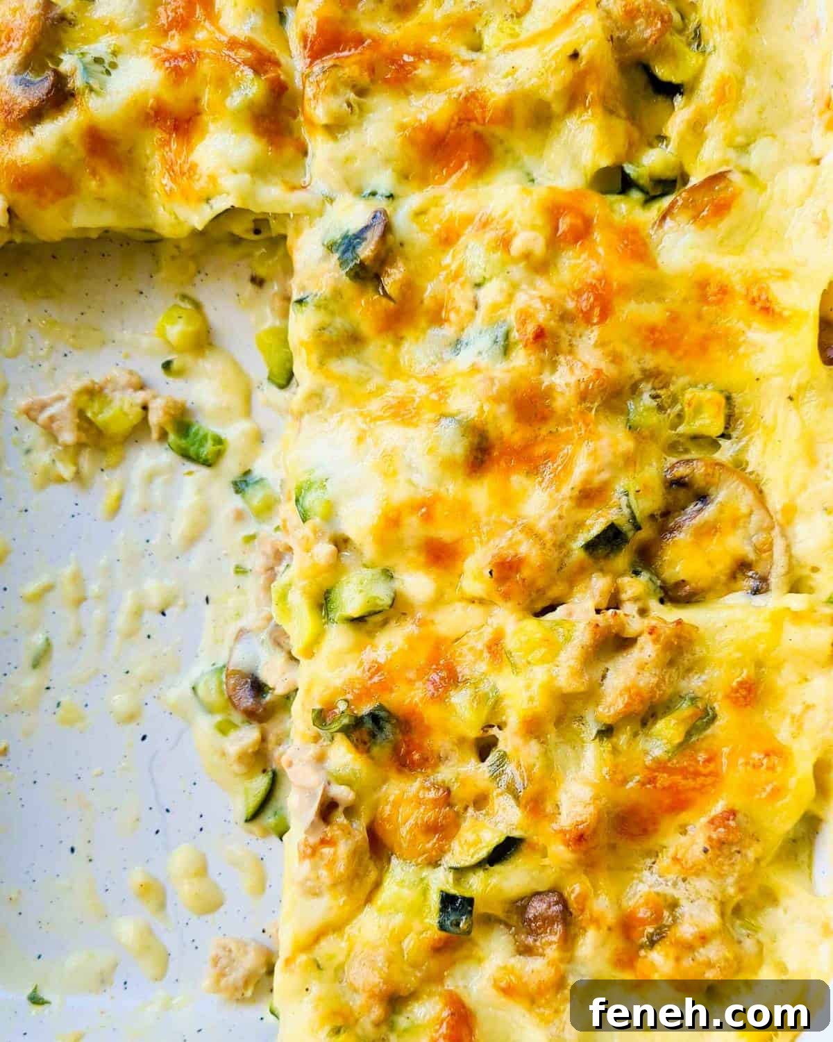 Slices of chicken lasagna in a baking dish