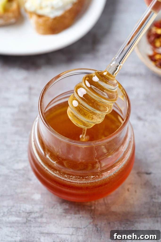 hot honey in a small jar with a dipper