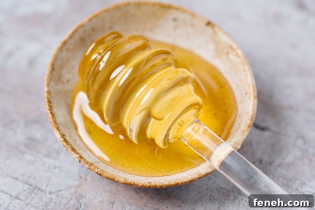 hot honey in a small bowl with a dipper