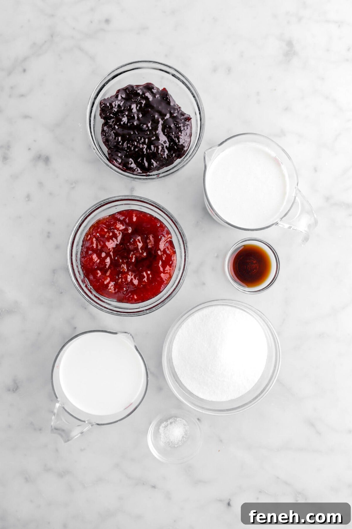blackberry jam, strawberry jam, heavy cream, vanilla, granulated sugar, whole milk, and salt on marble surface.