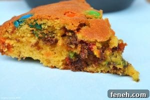 My M&M Cookie Pie has a slightly dense and soft middle and a chewy cookie outside and packed full of chocolate chips and M&Ms! 