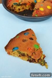 My M&M Cookie Pie has a slightly dense and soft middle and a chewy cookie outside and packed full of chocolate chips and M&Ms!