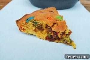 My M&M Cookie Pie has a slightly dense and soft middle and a chewy cookie outside and packed full of chocolate chips and M&Ms!