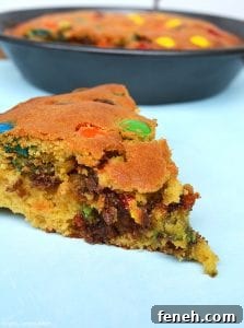 My M&M Cookie Pie has a slightly dense and soft middle and a chewy cookie outside and packed full of chocolate chips and M&Ms!