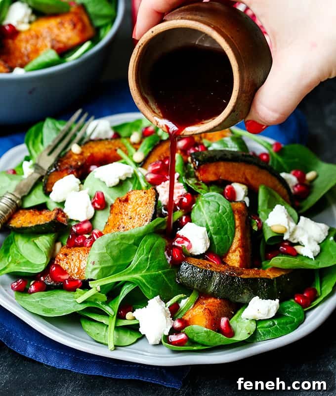 Sweet Roasted Kabocha Squash Salad - with creamy goat's cheese and a tangy pomegranate dressing. A deliciously filling dinner - perfect for Meatless Monday!