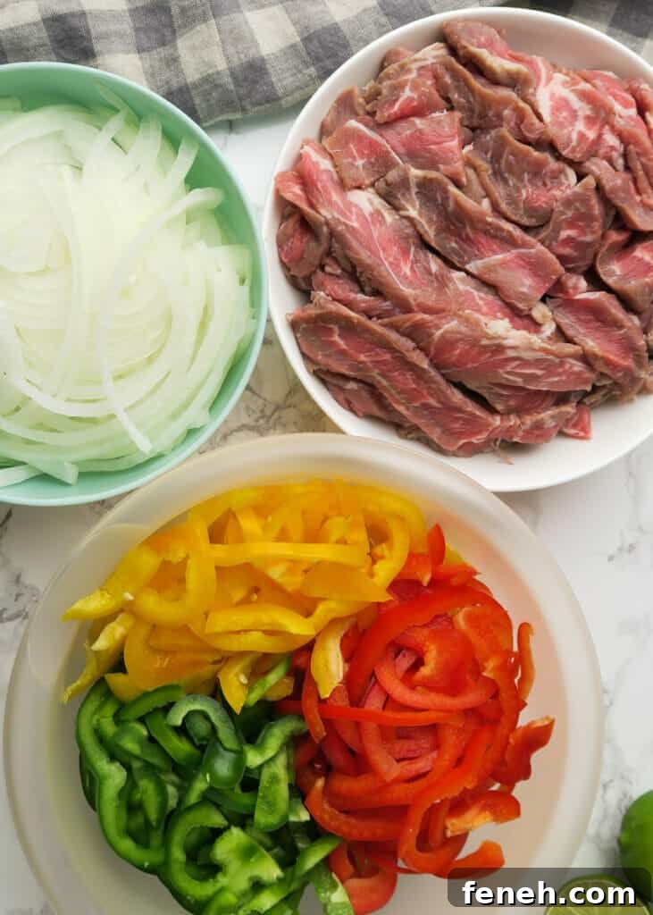 sliced petite sirloin steak and sliced bell peppers and onions