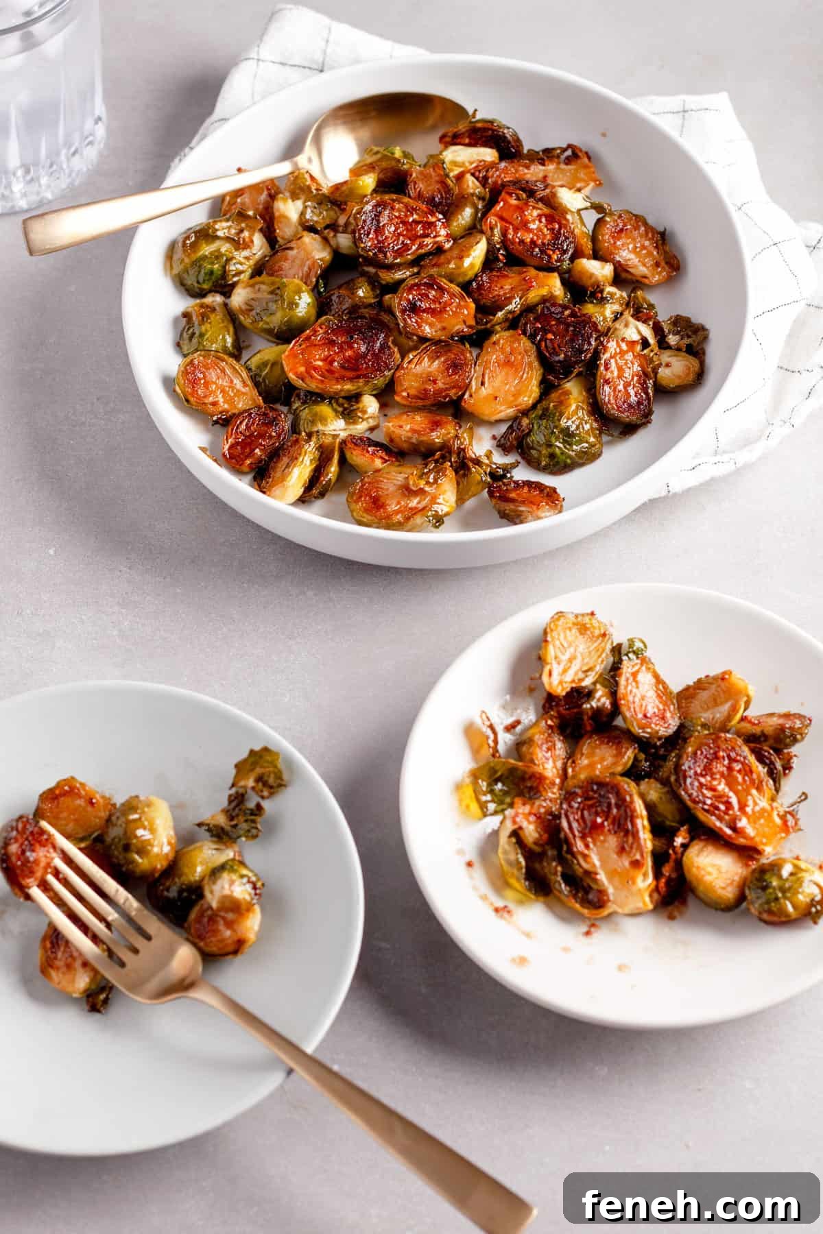Maple balsamic Brussels sprouts on a serving bowl with a couple small portions to the side.