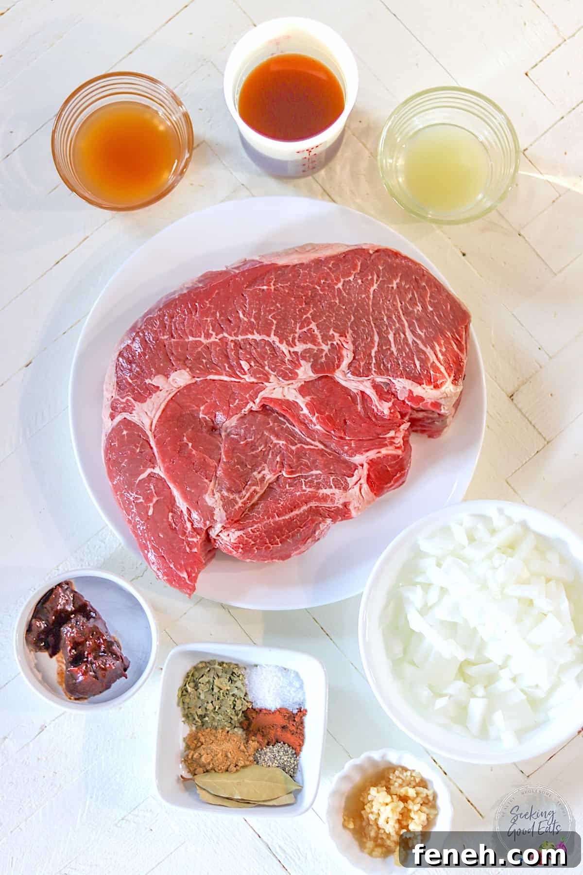 Ingredients needed for making copycat chipotle barbacoa beef recipe on a wooden white board.