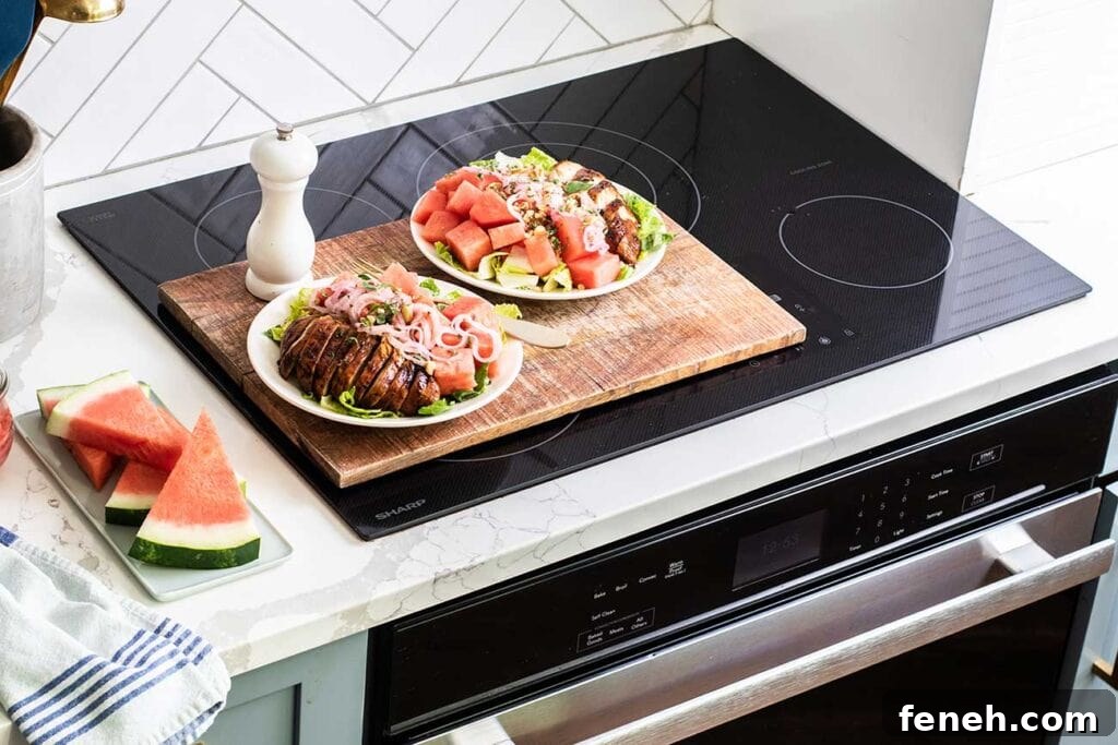 Two watermelon balsamic chicken salads sitting on top of the Sharp Induction Cooktop.