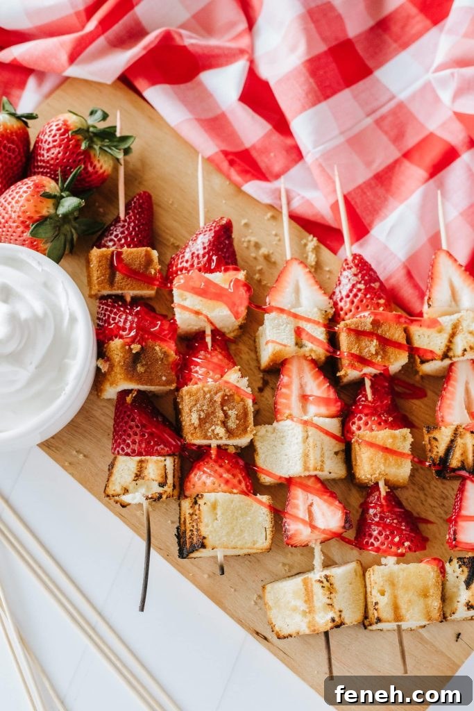 grilled strawberry shortcake kabobs on a wooden cutting board