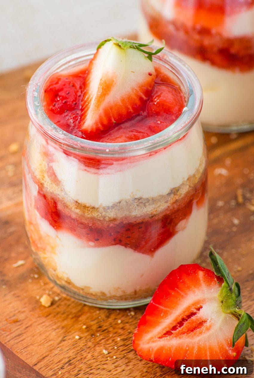 strawberry cheesecake cups on a wooden cutting board