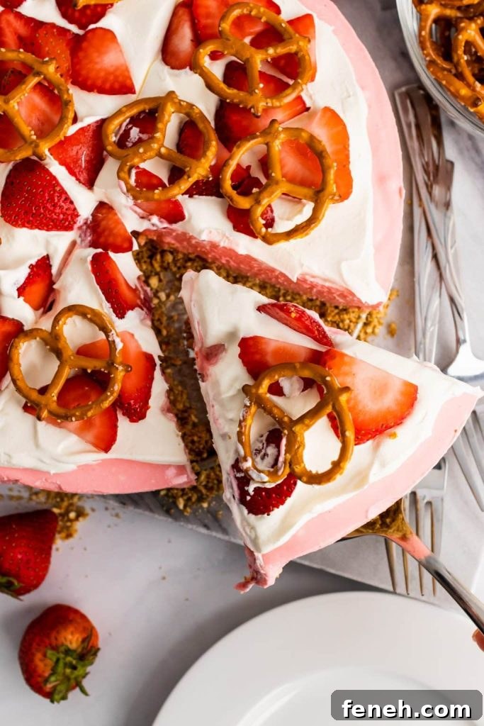 a silver spatula lifting up a slice of strawberry pretzel pie