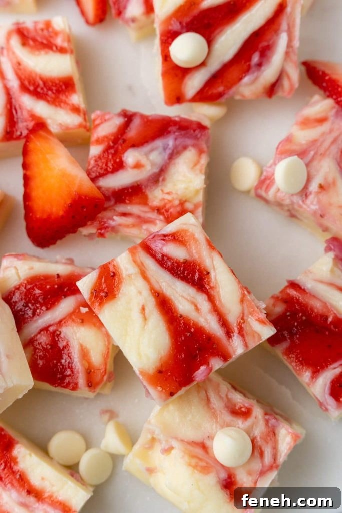 squares of strawberries and cream fudge on a marble countertop