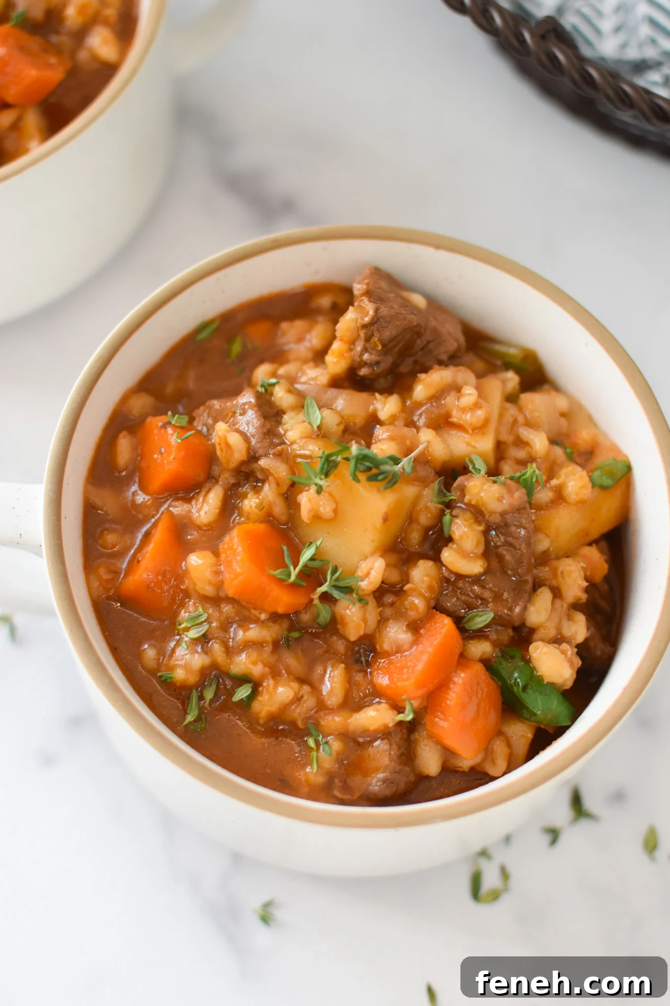 Slow Cooker Beef Barley Soup in a white bowl 
