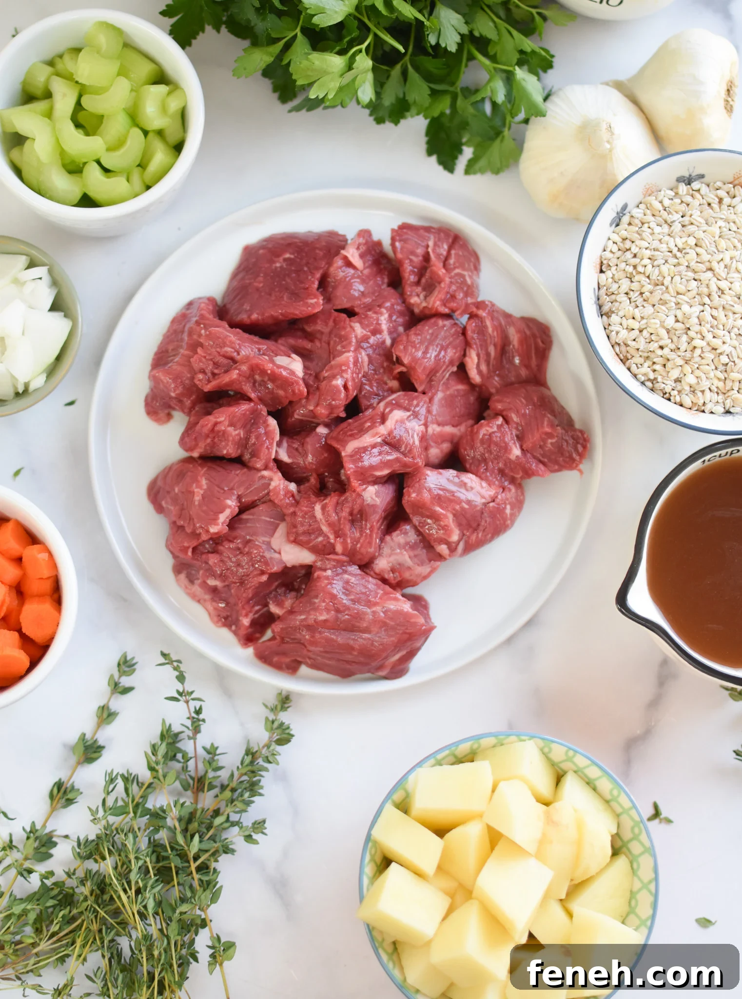 Slow Cooker Beef Barley Soup ingredients on a white countertop