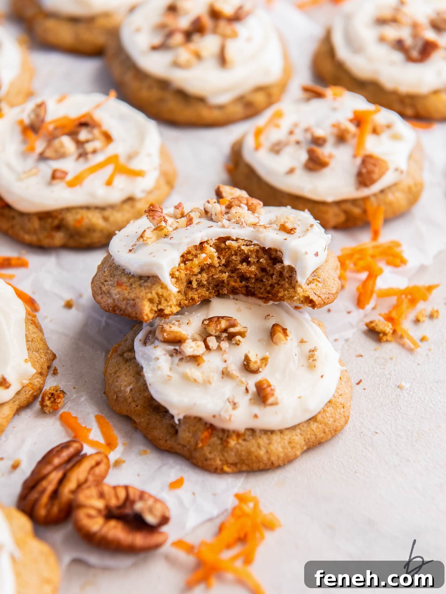 carrot cake cookie with a bite leaning on top of another cookie.