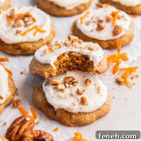 carrot cake cookie with a bite leaning on top of another cookie.