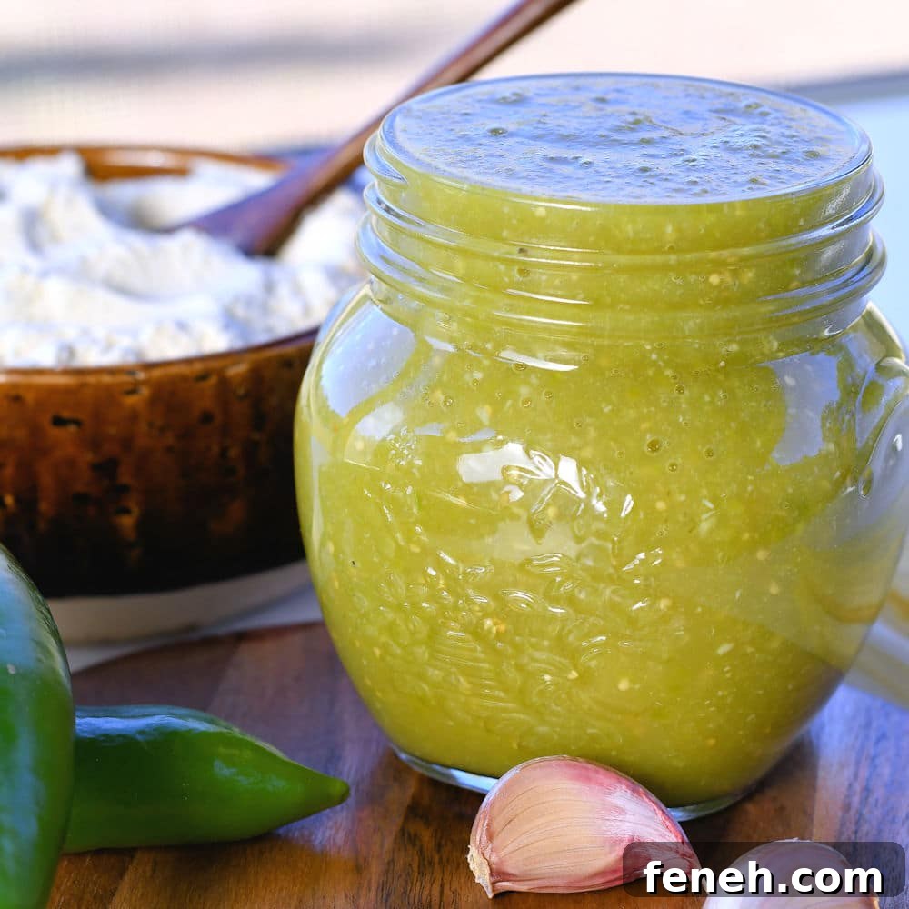 24bite: homemade verde tamale sauce in a jar with anaheim and garlic cloves with a bowl of masa harina in the background