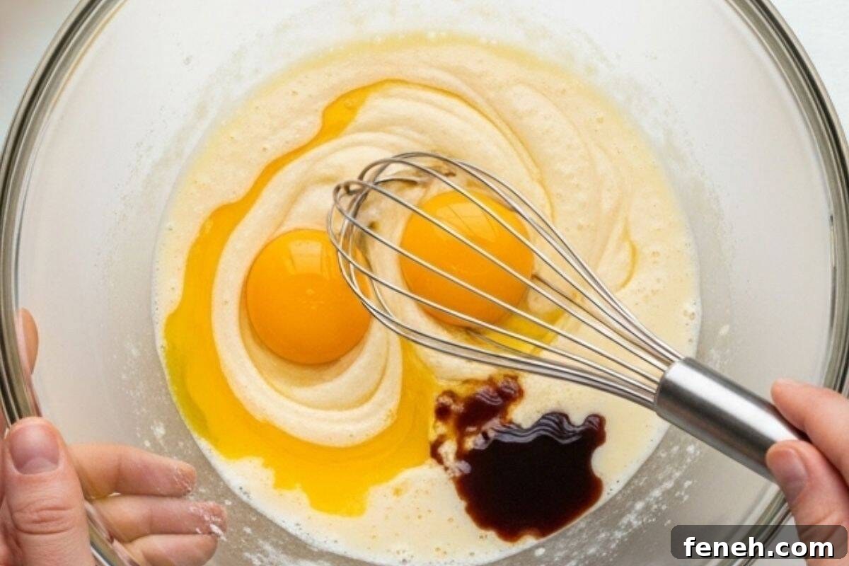whisk egg yolks with oil, mil and vanilla extract until smooth