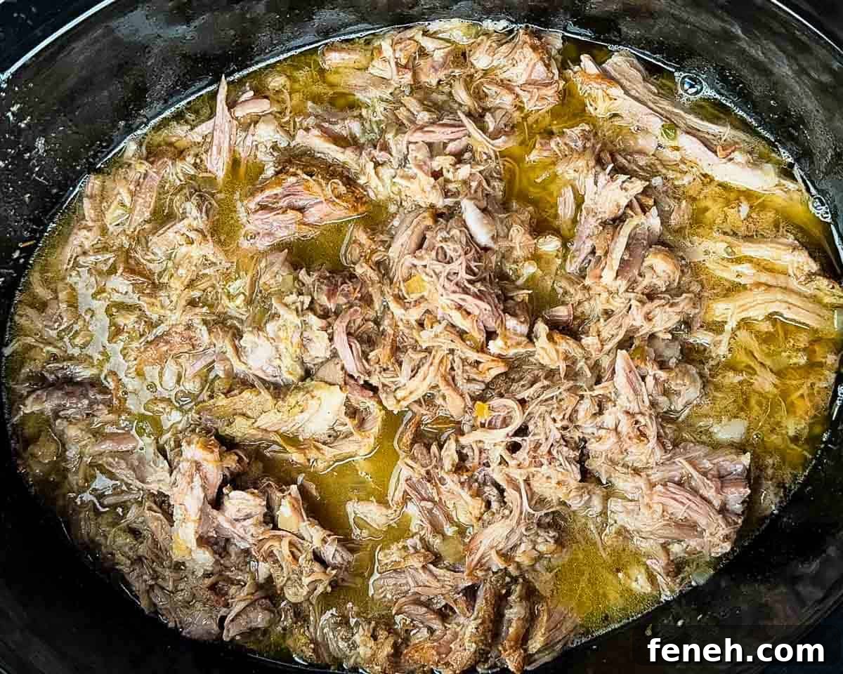 The shredded pork in the slow cooker with all the juices.