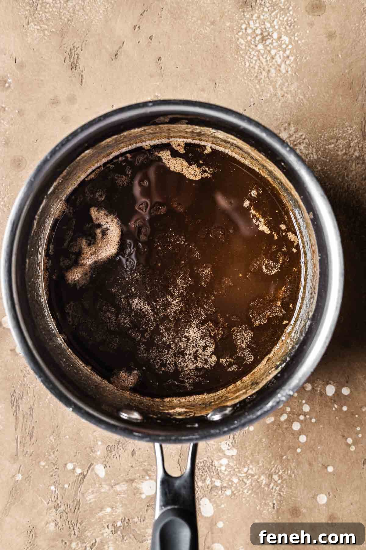 A pot with melted butter and brown sugar.