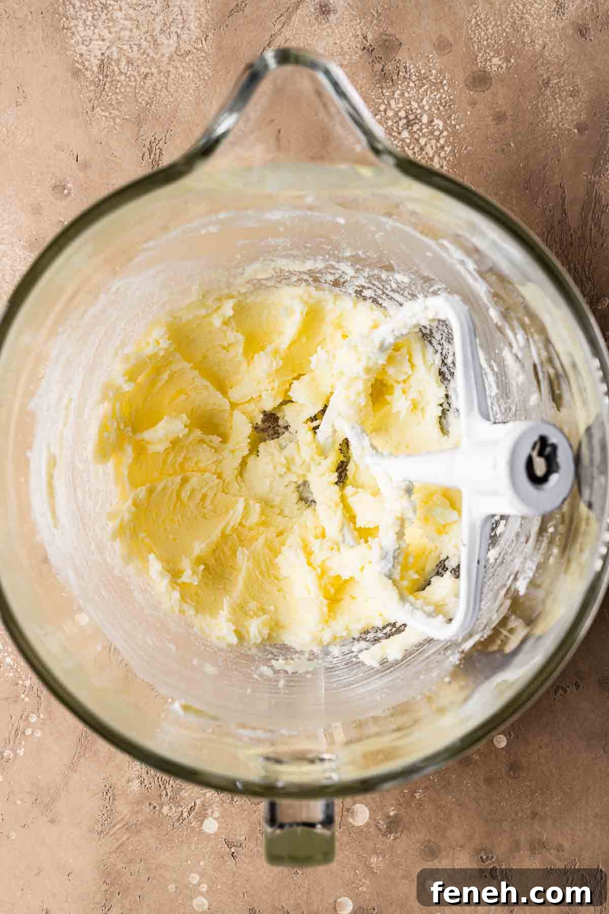 A mixing bowl with butter and sugar blended together.