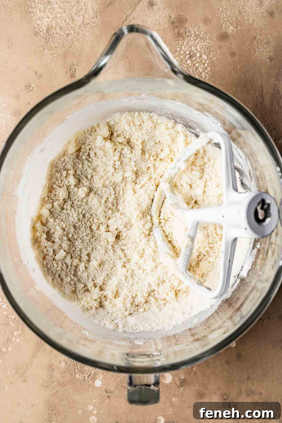 A mixing bowl with flour added to butter and sugar. 