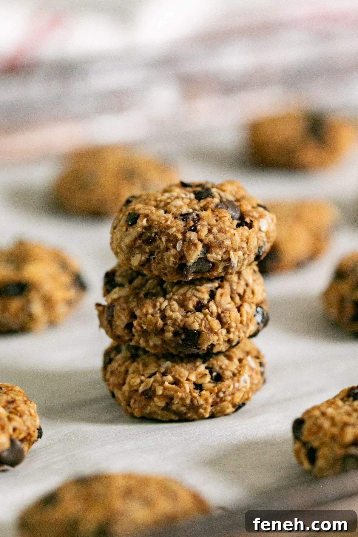 3 breakfast cookies stacked on each other with the other cookies around it.