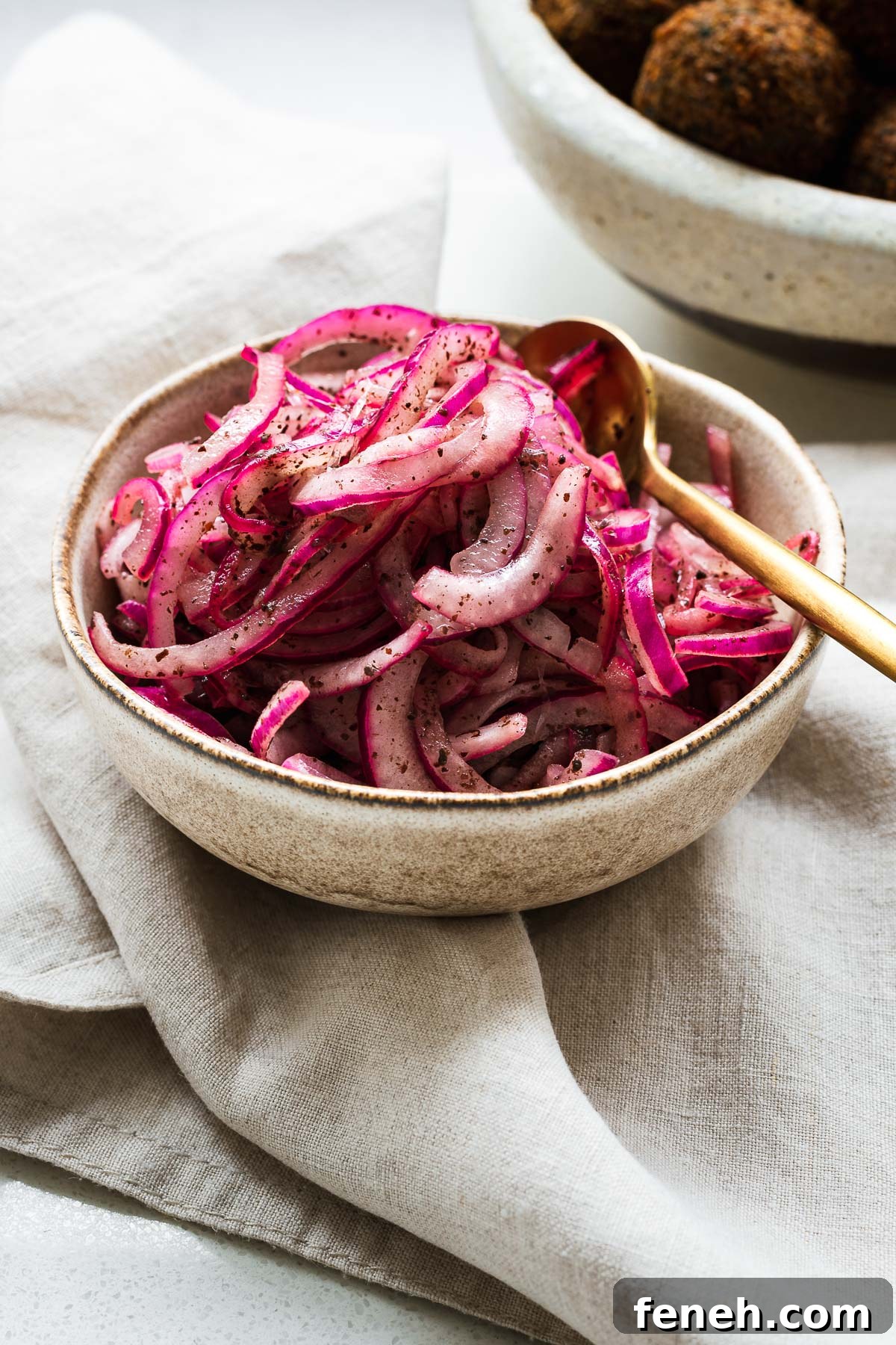 Red sumac onions in a small bowl.