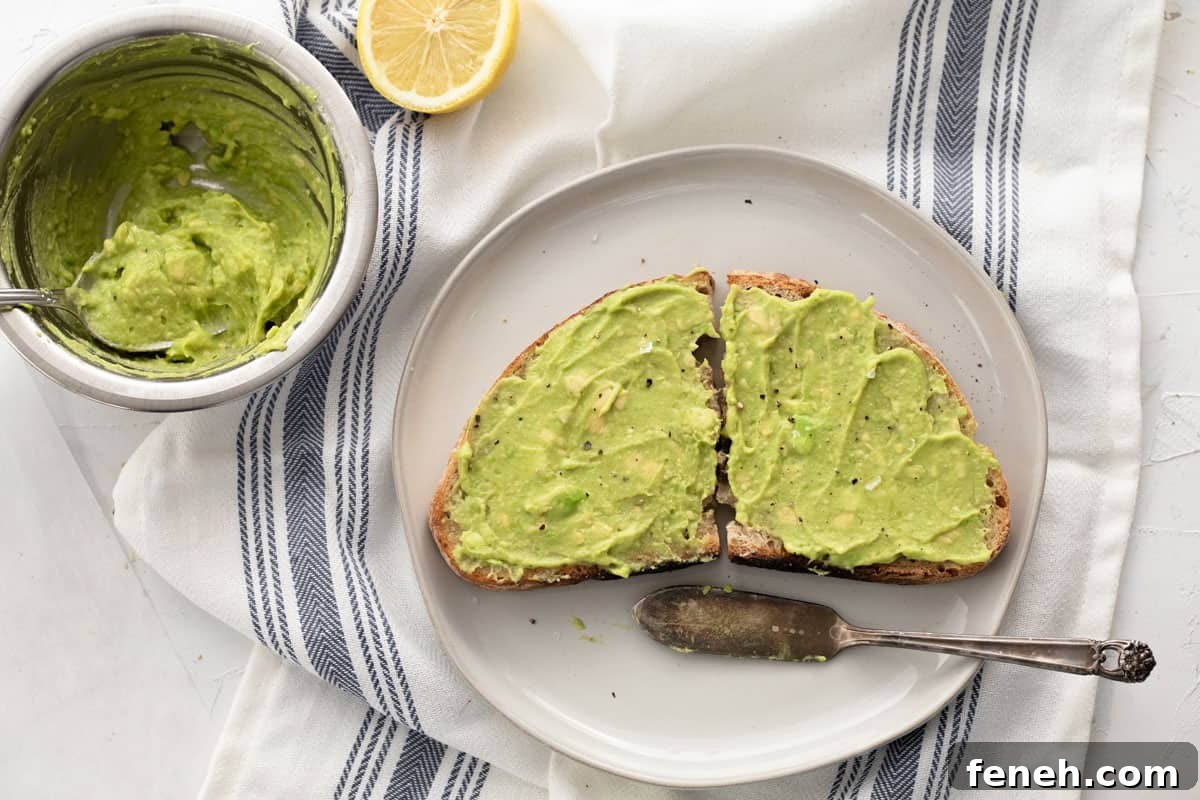 3-Ingredient Dunkin’ Style Avocado Toast Recipe 2 Sourdough bread with avocado spread on top cut in half